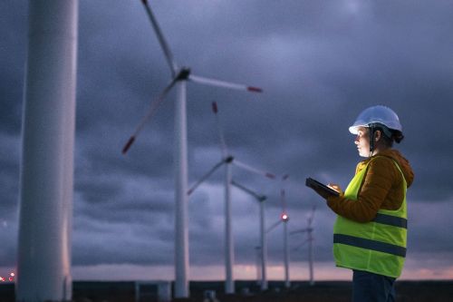 wind turbine technician evaluating structure